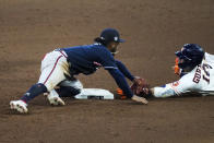 Houston Astros' Yuli Gurriel is tagged out by Atlanta Braves second baseman Ozzie Albies at second during the eighth inning of Game 1 in baseball's World Series between the Houston Astros and the Atlanta Braves Tuesday, Oct. 26, 2021, in Houston (AP Photo/Eric Gay)