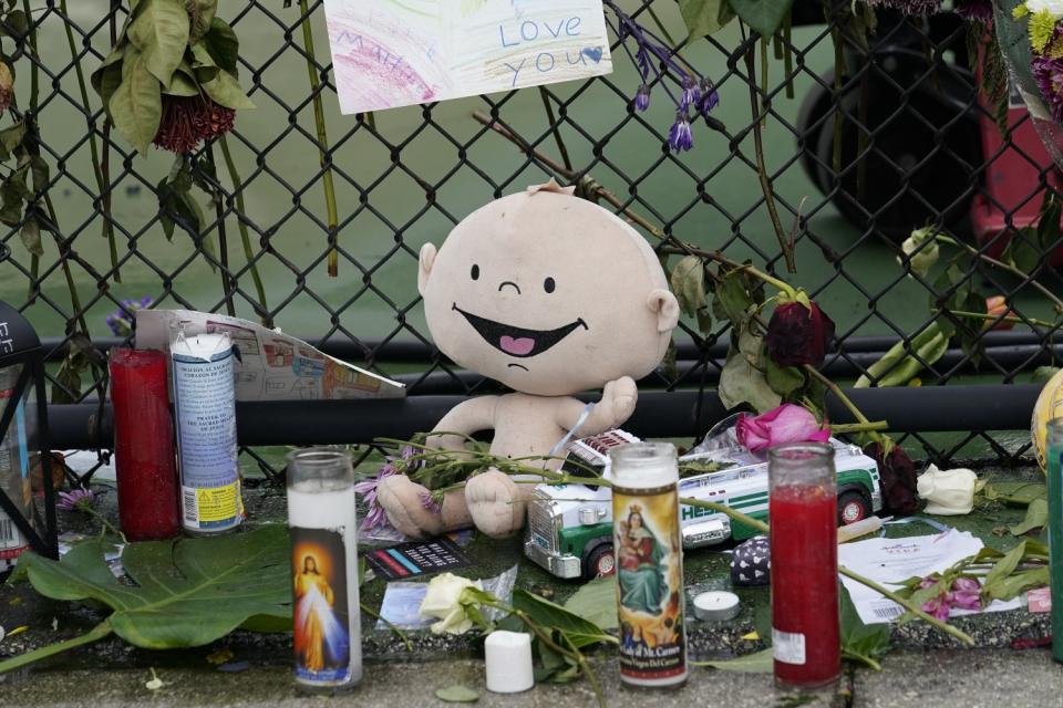 Toys, candles and flowers at the memorial outside St. Joseph Catholic Church near the Champlain Towers South