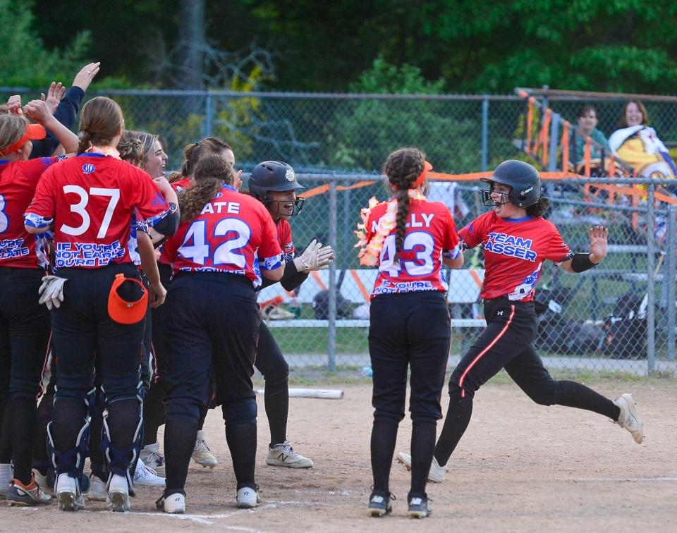 Taunton’s Mia Fernandes is met by teammates after hitting a home run during Wednesday’s game against Bishop Feehan.