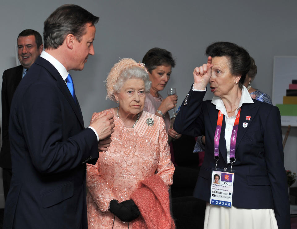 Britain's Queen Elizabeth II (C) and Prime Minister David Cameron (L) chat with Britain's Princess Anne as they arrive on July 27, 2012 at the Olympic Stadium in London, for the opening ceremony of the London 2012 Olympic Games . 
 AFP PHOTO / POOL / JOHN STILLWELL        (Photo credit should read JOHN STILLWELL/AFP/GettyImages)