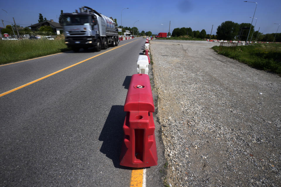 A truck passes on a road under construction in Caponago, near Milan, Italy, Thursday, May 12, 2022. Russia's war in Ukraine has accelerated inflation across Europe, with prices for energy, materials and food surging at rates not seen for decades. Inflation is expected to hit nearly 7% this year in the 27-nation EU and is contributing to slowing growth forecasts. (AP Photo/Antonio Calanni)