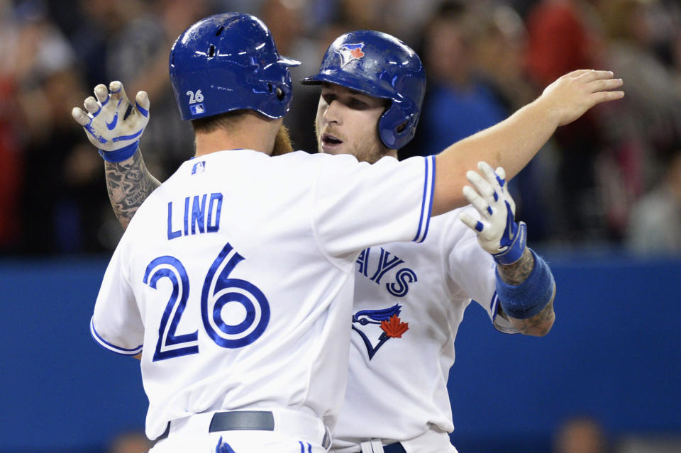 Toronto Blue Jays' Adam Lind (26) congratulates teammate Brett Lawrie on his two-run homerun against the Los Angeles Angels during sixth inning American League baseball action in Toronto on Monday, May 12, 2014. (AP Photo/The Canadian Press, Frank Gunn)