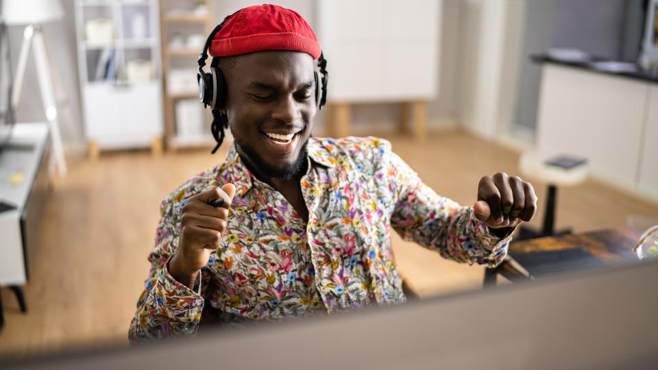 Man at a computer jamming out to music