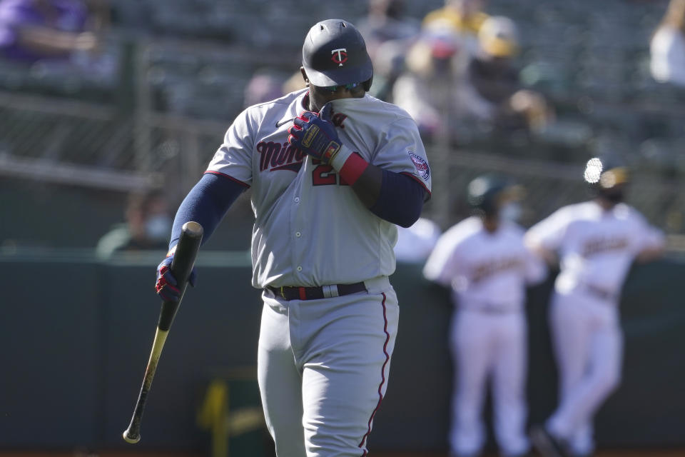 Minnesota Twins' Miguel Sano walks to the dugout after striking out against the Oakland Athletics during the fourth inning of the first baseball game of a doubleheader in Oakland, Calif., Tuesday, April 20, 2021. (AP Photo/Jeff Chiu)