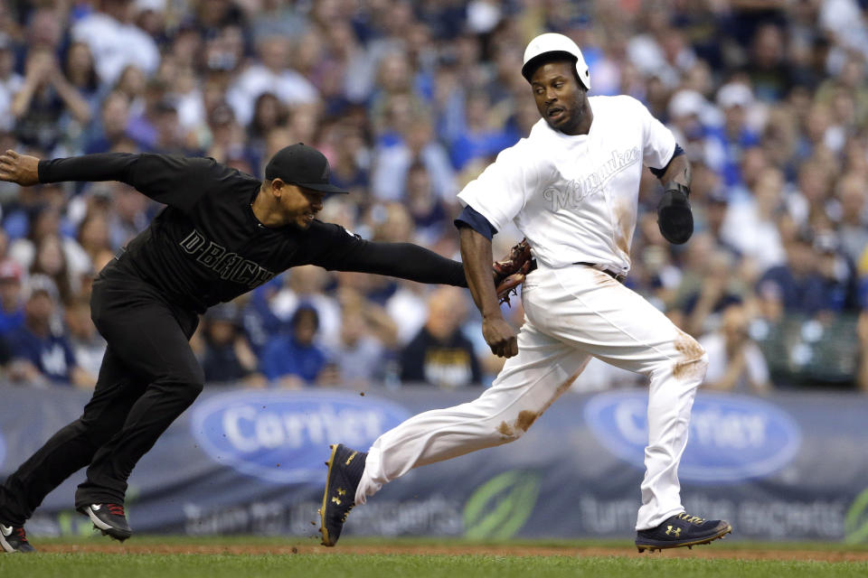 Milwaukee Brewers' Lorenzo Cain, right, is tagged out by Arizona Diamondbacks' Eduardo Escobar after being caught in a rundown during the third inning of a baseball game Saturday, Aug. 24, 2019, in Milwaukee. (AP Photo/Aaron Gash)