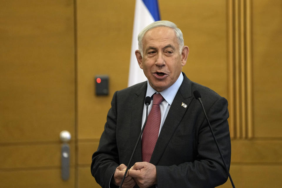 Israeli Prime Minister Benjamin Netanyahu speaks to members of his Likud Party at the Knesset, Israel's parliament, in Jerusalem, Monday, March 13, 2023. Netanyahu spoke as his coalition pressed ahead with a contentious plan to overhaul the country's judicial system. Speaking to members of his party, he lashed out at the Israeli media, saying they are broadcasting a "never ending tsunami of fake news" against him. He reiterated his claim that the legal overhaul will strengthen Israeli democracy. (AP Photo/Ohad Zwigenberg)