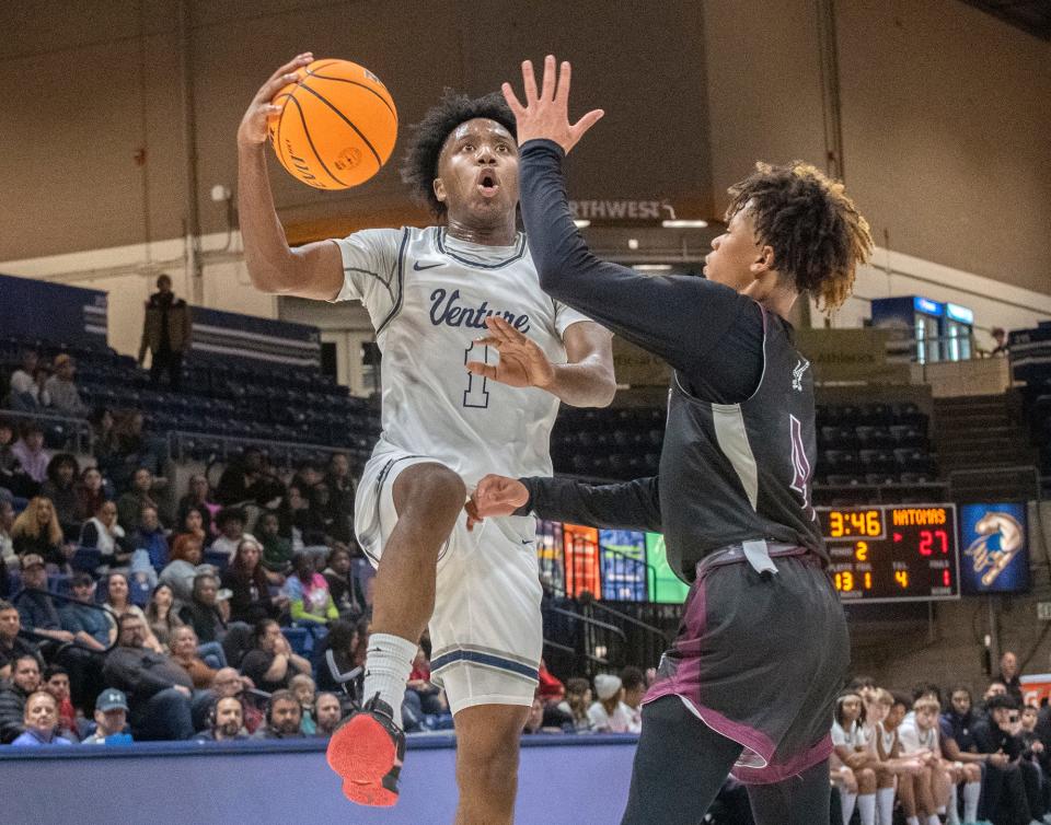 Venture Academy's Toriano Woods, Jr.., left, goes to the hoop against Natomas's Manno Jenkins during the Sac-Joaquin Section Div. 4 boys basketball championship game at U.C. Davis' University Credit Union Center in Davis on Feb. 23, 2024. Venture Academy won 78-74.