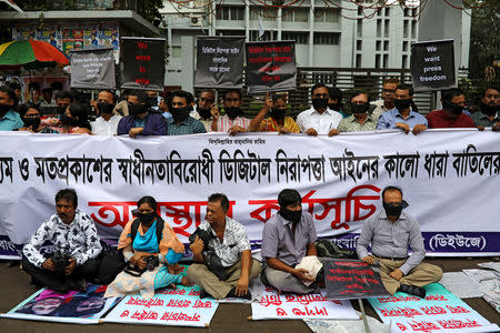FILE PHOTO: Journalists hold banners and placards as they protest against the newly passed Digital Security Act in front of the Press Club in Dhaka, Bangladesh, October 11, 2018. REUTERS/Mohammad Ponir Hossain/File Photo