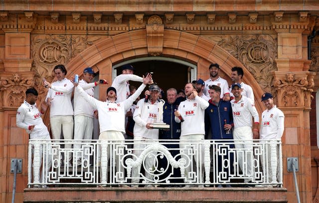 Feroze Khushi, far left, recoils after beer is poured on him during the trophy celebration