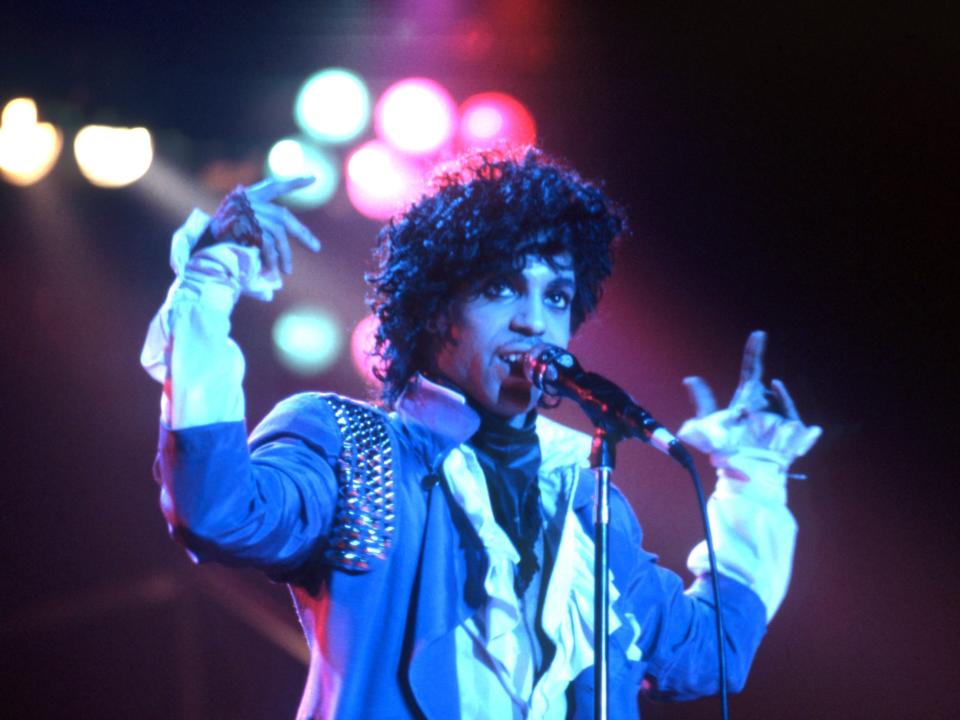 Prince performs onstage during the 1984 Purple Rain Tour.