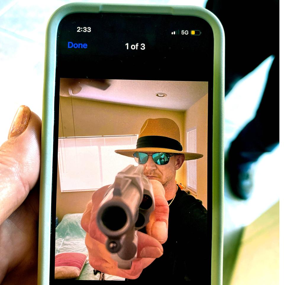 Former Royal Palm Beach High School math teacher Robert Krasnicki points a gun in a text message.