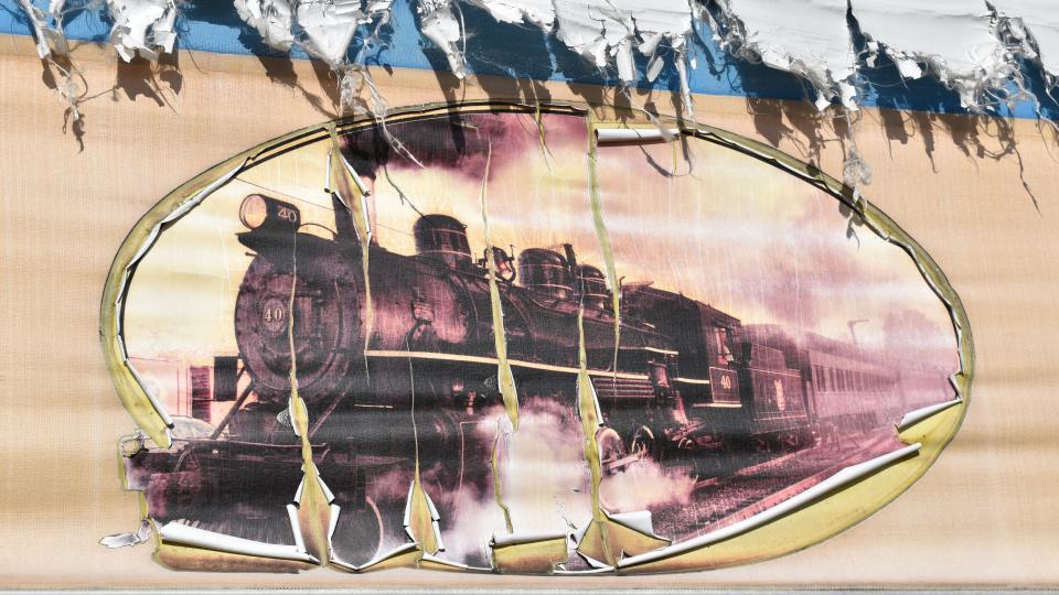 A deteriorated image of a steam locomotive is on a wall at the former Toy Store Emporium in Cherry Hill.