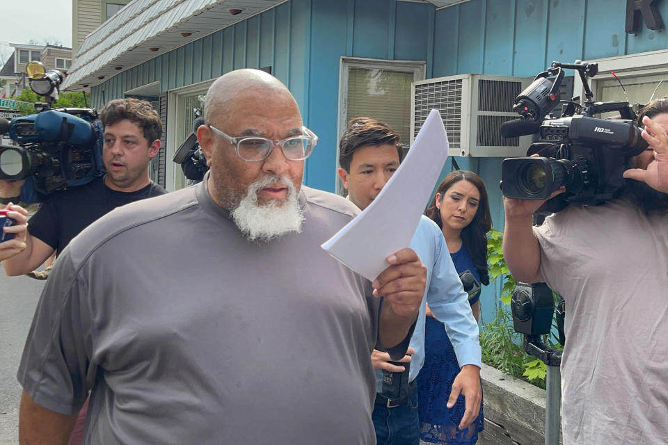 Concord, NH - June 14: Former Harvard Medical School morgue manager Cedric Lodge, 55, shields his face with a printout of the indictment against him as he walked from the Warren B. Rudman United States Courthouse, following his arrest on charges related to an alleged scheme to steal and sell donated body parts. (Photo by Steven Porter/The Boston Globe via Getty Images)