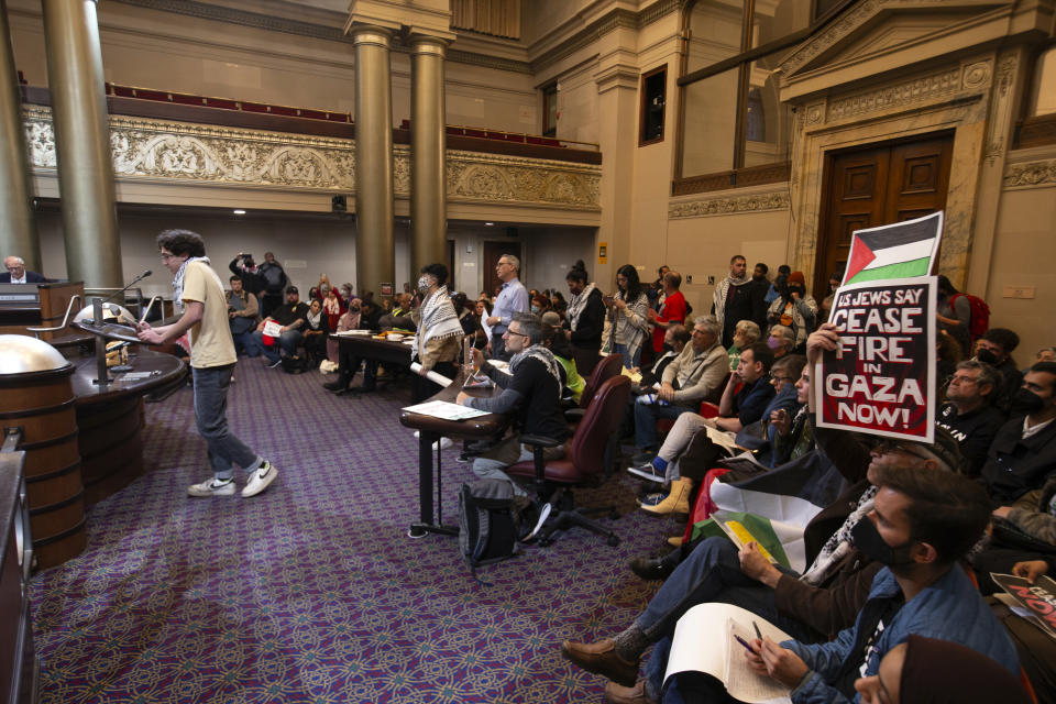 Audience members listen to public comment at a special session of the Oakland City Council about a resolution calling for an immediate cease-fire in Gaza, Monday, Nov. 27, 2023, in Oakland, Calif. (AP Photo/D. Ross Cameron)