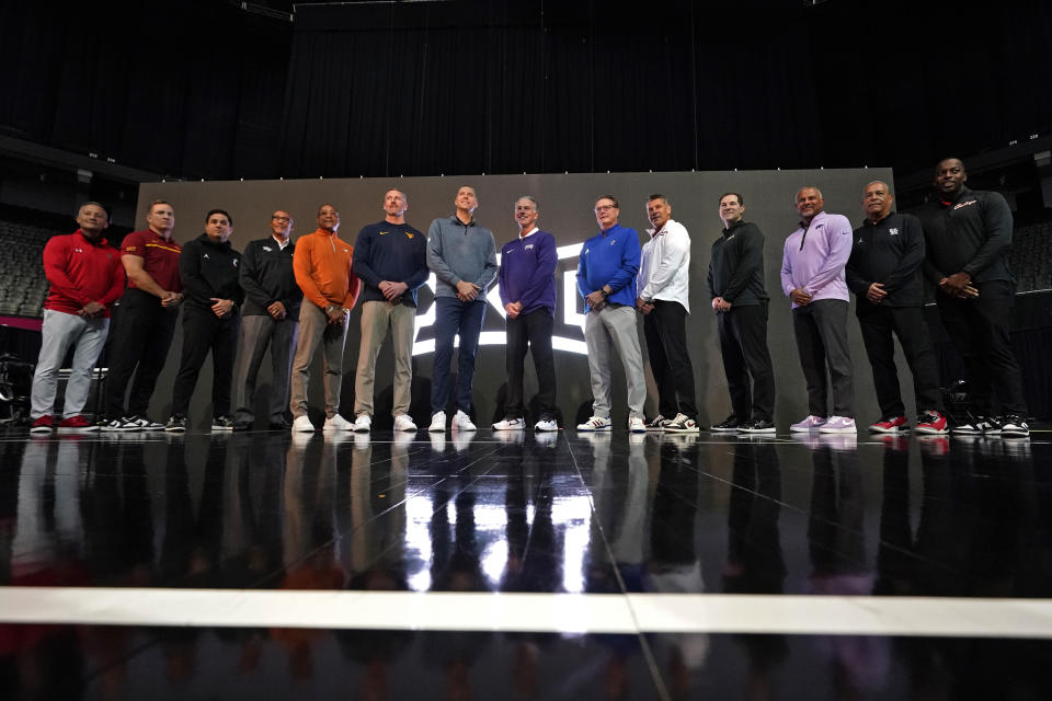 Big 12 coaches pose for a group photo during the NCAA college Big 12 men's basketball media day Wednesday, Oct. 18, 2023, in Kansas City, Mo. (AP Photo/Charlie Riedel)