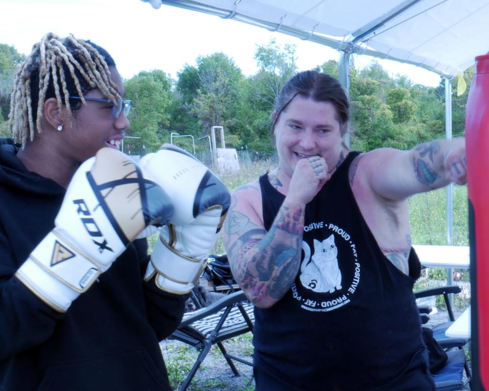 Lore McSpadden-Walker, right, models a boxing pattern for a client during a Positive Force Movement session, their classes that teach people how to move in ways that work for their bodies.