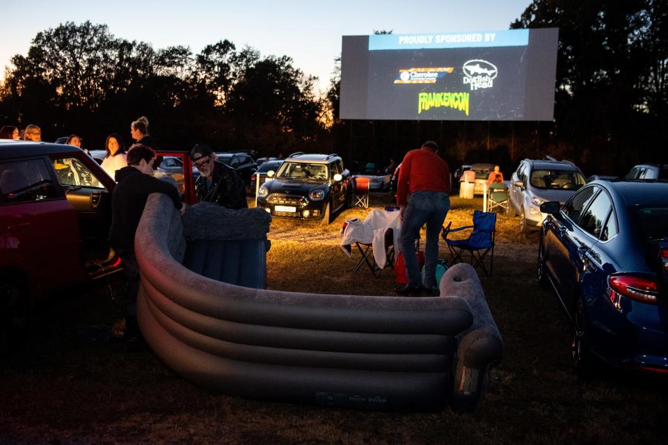 Ange Schroeder and Chad Quist inflate an inflatable couch before the start of the Knoxville Horror Film Fest at the Parkway Drive-In in Maryville on Friday, Oct. 21, 2022. 