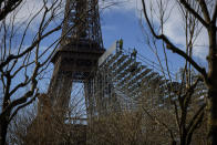 Workers build the stands for the upcoming summer Olympic Games on the Champ-de-Mars just beside the Eiffel Tower, in Paris, Monday, April 1, 2024 in Paris. The Paris 2024 Olympic Games will run from July 26 to Aug.11, 2024. (AP Photo/Thomas Padilla)