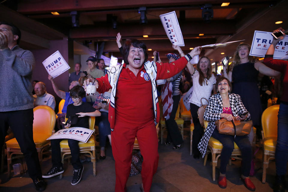 Nellie Gillogly, center, of Santa Ana, joins Republicans erupting in celebration as a newscaster announces Donald Trump wins Florida while watching election night results at the OCGOP election party at China Palace in Newport Beach, California, on Nov. 8.