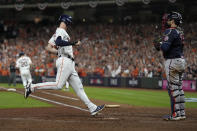 Houston Astros' Kyle Tucker scores on an error during the fourth inning of Game 1 in baseball's World Series between the Houston Astros and the Atlanta Braves Tuesday, Oct. 26, 2021, in Houston. (AP Photo/Ashley Landis)