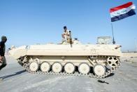 Iraqi army forces guard at the entrance of Umm Qasr Port as protesters block the road during ongoing anti-government protests, south of Basra