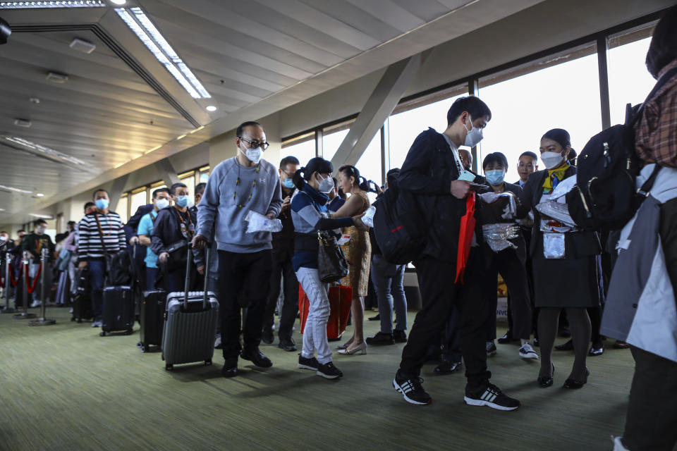 Over a hundred Chinese tourists from Xiamen, China arrive at the Ninoy Aquino International Airport in Manila on Tuesday, Jan. 24, 2023. The expected resumption of group tours from China is likely to bring far more visitors. (AP Photo/Gerard V. Carreon)