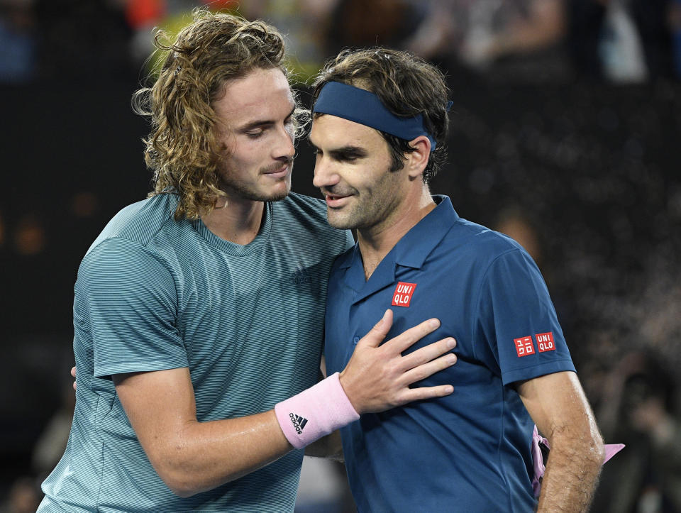 El suizo Roger Federer felicita al griego Stefanos Tsitsipas, izquierda, por su triunfo en el partido de cuarta ronda del Abierto de Australia en Melbourne, Australia, el domingo 20 de enero del 2019. (AP Foto/Andy Brownbill)