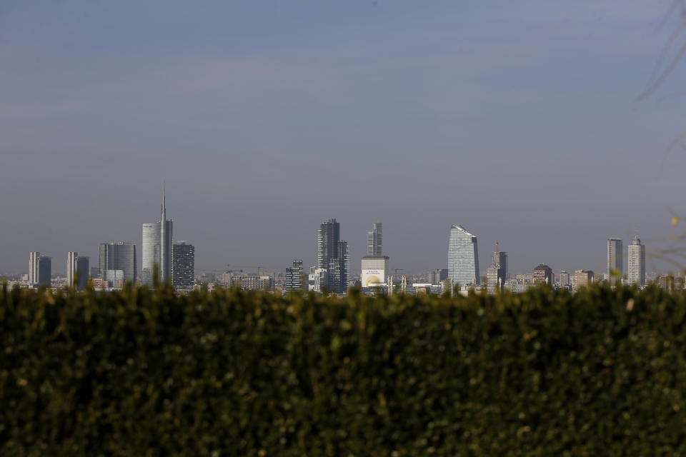 In this photo taken on Wednesday, Oct. 25, 2017, the skyline seen from the roof of Martini Terrace, in Milan, Italy. The eurozone's third-largest economy and a major exporter, Italy on Wednesday becomes the first western industrialized nation to idle swaths of industrial production to stop the spread of coronavirus by keeping yet more of the population at home. The new coronavirus causes mild or moderate symptoms for most people, but for some, especially older adults and people with existing health problems, it can cause more severe illness or death. (AP Photo/Luca Bruno, File)