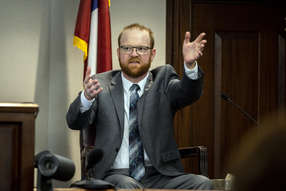 Travis McMichael speaks from the witness stand during his trial Wednesday, Nov. 17, 2021, in Brunswick, Ga. McMichael, his father Greg McMichael and their neighbor, William "Roddie" Bryan, are charged with the February 2020 death of 25-year-old Ahmaud Arbery. (AP Photo/Stephen B. Morton, Pool)