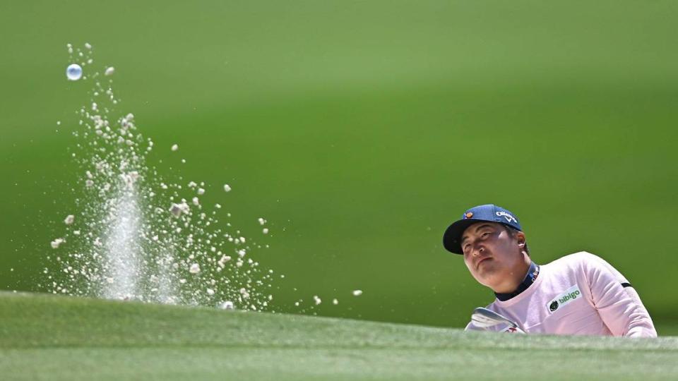 Kyoung-Hoon Lee watches the flight of his ball from a bunker along the 15th green during first-round action of the Wells Fargo Championship at Quail Hollow Club in Charlotte. Lee finished the first round with a 66.