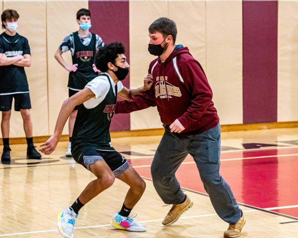 Old Colony assistant coach Paul Soucy trains Xavier Pratt on how to create space.