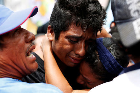 Relatives react during the burial of police officer Juan Jimenez, who was a victim of the earthquake that struck the southern coast of Mexico late on Thursday, in Juchitan, Mexico September 10, 2017. REUTERS/Carlos Jasso