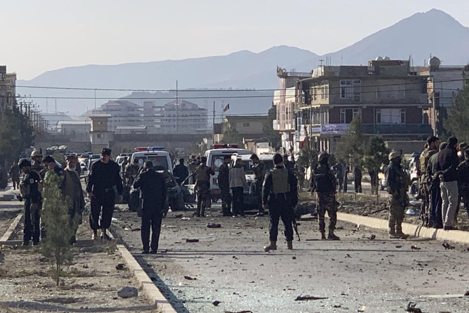 Afghan security personnel gather at the site of an explosion in Kabul, Afghanistan, Wednesday, Nov. 13, 2019. An explosion has rocked the Afghan capital of Kabul as early morning commuters were on the street heading to work. (AP Photo/Rahmat Gul)