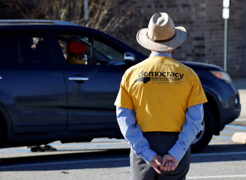 FILE PHOTO: Non-partisan observer watches curbside voting outside polling station in Graham, North Carolina