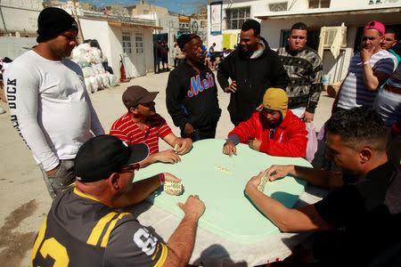 Cuban migrants, waiting for their appointment to request asylum in the U.S., play dominoes at a church being used as a shelter in Ciudad Juarez, Mexico, February 25, 2019. REUTERS/Jose Luis Gonzalez