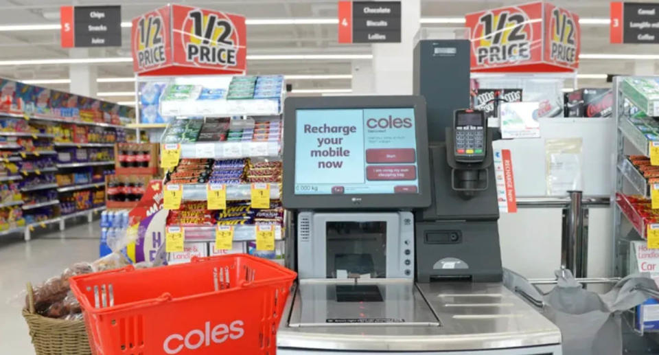 Coles basket at self-serve checkout inside store. 