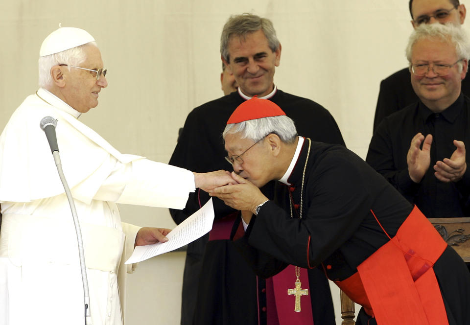 FILE - Chinese Cardinal Joseph Zen, right, Bishop of Hong Kong, kisses the hand of Pope Benedict XVI after the traditional Angelus prayer in Lorenzago di Cadore, near Belluno, Italy, Sunday, July 22, 2007. Zen will leave the southern Chinese city of Hong Kong this week to pay his respects to the late Pope Emeritus Benedict XVI in Vatican City, his secretary said on Tuesday, Jan. 3, 2022. (AP Photo/Antonio Calanni, File)