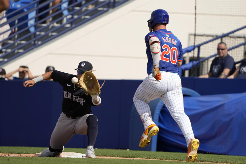 New York Mets' Pete Alonso (20) grounds out as New York Yankees first baseman Oswaldo Cabrera handles the throw during the fifth inning of a spring training baseball game Tuesday, March 5, 2024, in Port St. Lucie, Fla. (AP Photo/Jeff Roberson)