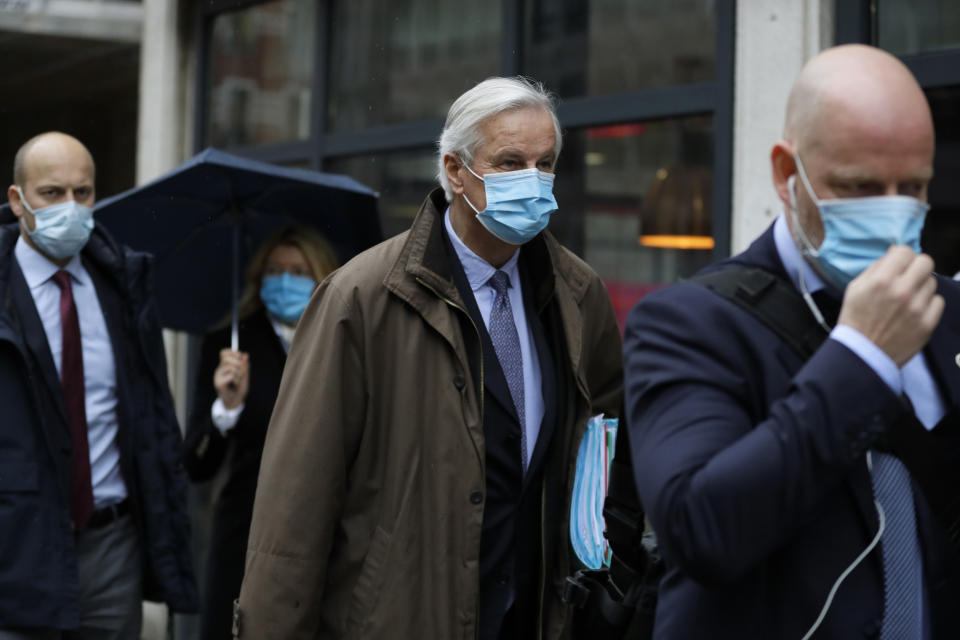 European Commission's Head of Task Force for Relations with the United Kingdom Michel Barnier, centre, walks to the Conference Centre in London, Thursday, Dec. 3, 2020. With less than one month to go before the U.K. exits the EU's economic orbit, talks are continuing, and U.K. officials have said this is the last week to strike a deal. (AP Photo/Kirsty Wigglesworth)