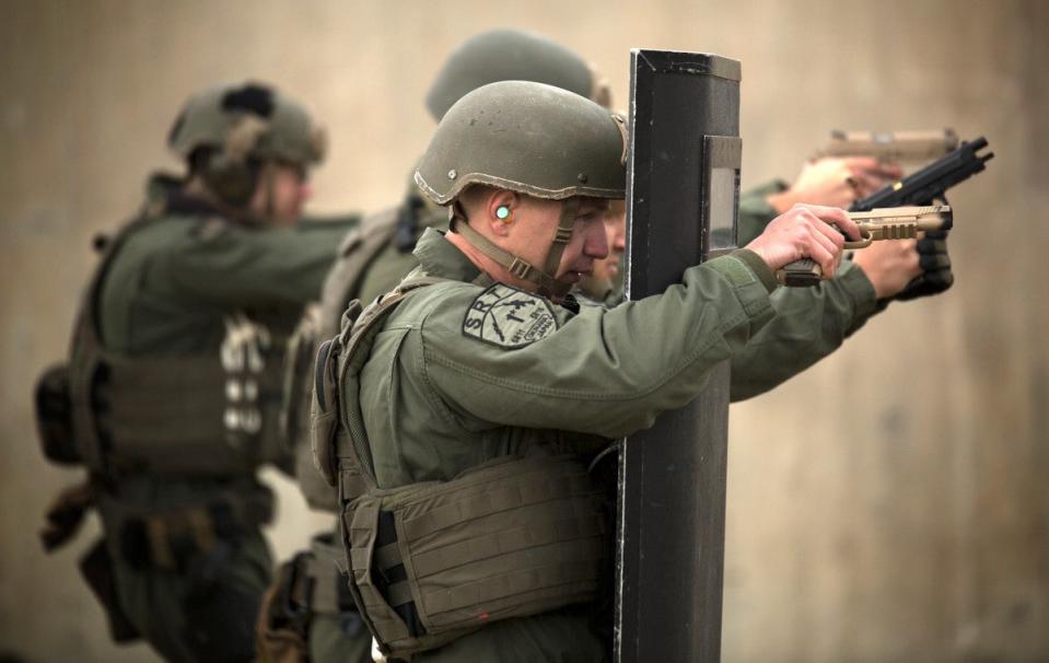 Members of a Marine Special Reaction Team train with M45A1s and other pistols, as well as ballistic shields, at Camp Hansen on the Japanese island of Okinawa. <em>USMC</em>