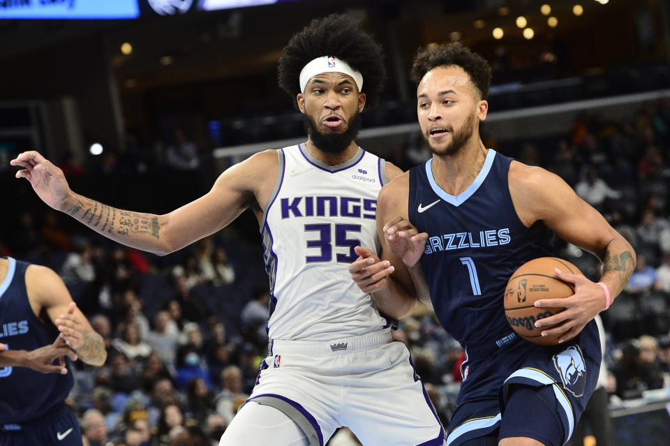 Memphis Grizzlies forward Kyle Anderson (1) handles the ball against the Sacramento Kings forward Marvin Bagley III (35) in the second half of an NBA basketball game Sunday, Nov. 28, 2021, in Memphis, Tenn. (AP Photo/Brandon Dill)