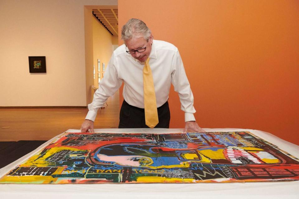 PHOTO: In this Feb. 2, 2022, file photo, Aaron De Groft, director of the Orlando Museum of Art, looks at one of the works from the Mumford storage locker said to be by Jean-Michel Basquiat, 'Untitled (Industry Insider),' at the museum in Orlando, Fla. (Melanie Metz/The New York Times via Redux, FILE)