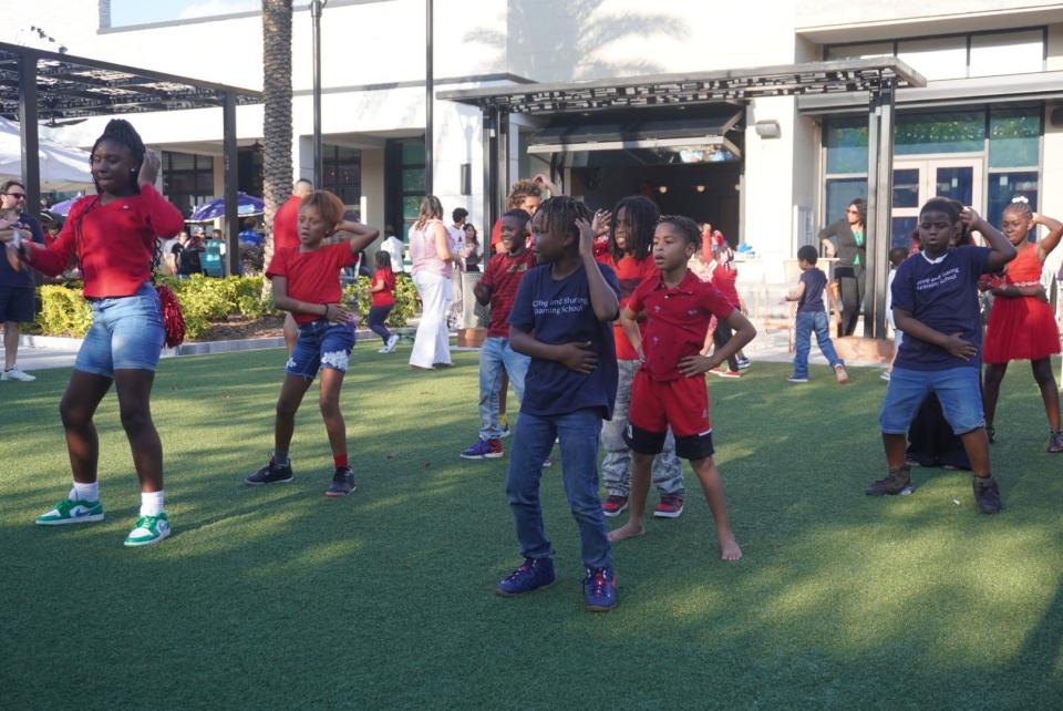 Children dance during the Amazing Give Wrap Party at the Celebration Pointe Promenade on Thursday.
(Credit: Photo provided by Voleer Thomas)