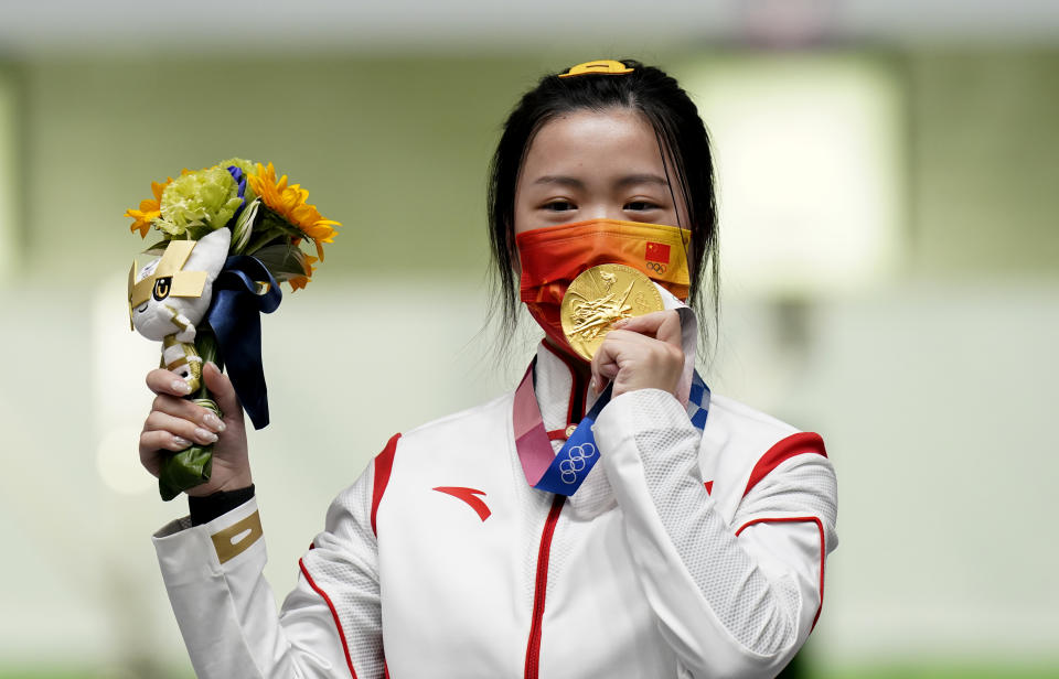 China's Qian Yang celebrates with her gold medal after winning the 10m Air Rifle Women's Final at the Asaka Shooting Range on the first day of the Tokyo 2020 Olympic Games in Japan. Picture date: Saturday July 24, 2021. (Photo by Danny Lawson/PA Images via Getty Images)