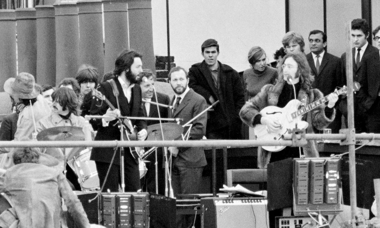 <span>The Beatles performing on the Apple Headquarters’ rooftop in London 1969. The performance was part of filming for the documentary Let It Be.</span><span>Photograph: Mirrorpix/Getty Images</span>