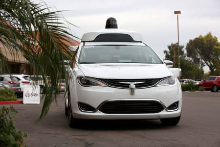 FILE PHOTO: A Waymo Chrysler Pacifica Hybrid self-driving vehicle approaches during a demonstration in Chandler, Arizona