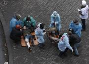 Injured men receive medical assistance in Independence Square in Kiev February 20, 2014. REUTERS/Vasily Fedosenko