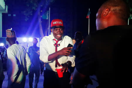 Supporters of Nigeria's President Muhammadu Buhari celebrate at the campaign headquarters of the All Progressives Congress (APC) party in Abuja, Nigeria February 26, 2019. REUTERS/Nneka Chile