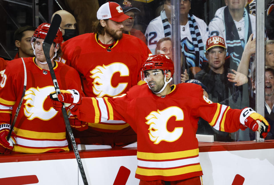 Calgary Flames forward Nazem Kadri, right, celebrates his goal with teammates during the second period of an NHL hockey game against the Seattle Kraken, Tuesday, Nov. 1, 2022 in Calgary, Alberta. (Jeff McIntosh/The Canadian Press via AP)