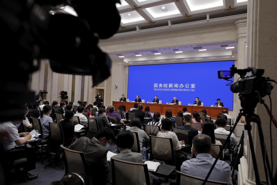 Journalists attend a press conference for the white paper on China's fighting of the Covid-19 coronavirus chaired by Xu Lin, vice head of the publicity department of the communist party, at the State Council Information Office in Beijing, Sunday, June 7, 2020. Senior Chinese health officials defended their country's response to the new coronavirus pandemic, saying they provided information in a timely and transparent manner. (AP Photo/Andy Wong)